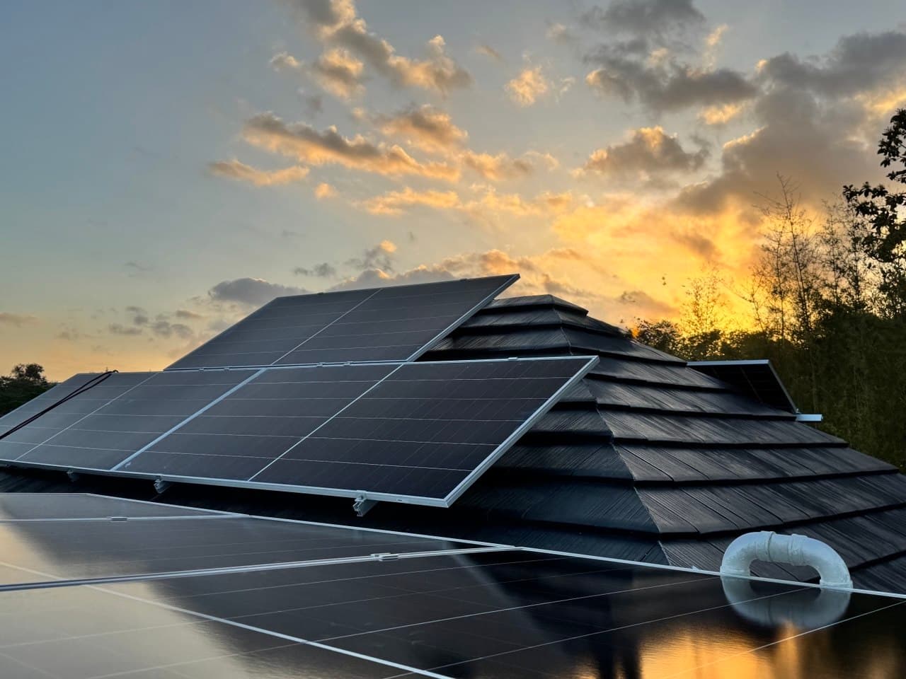 FEDGES solar panel installation on a residential rooftop at sunset